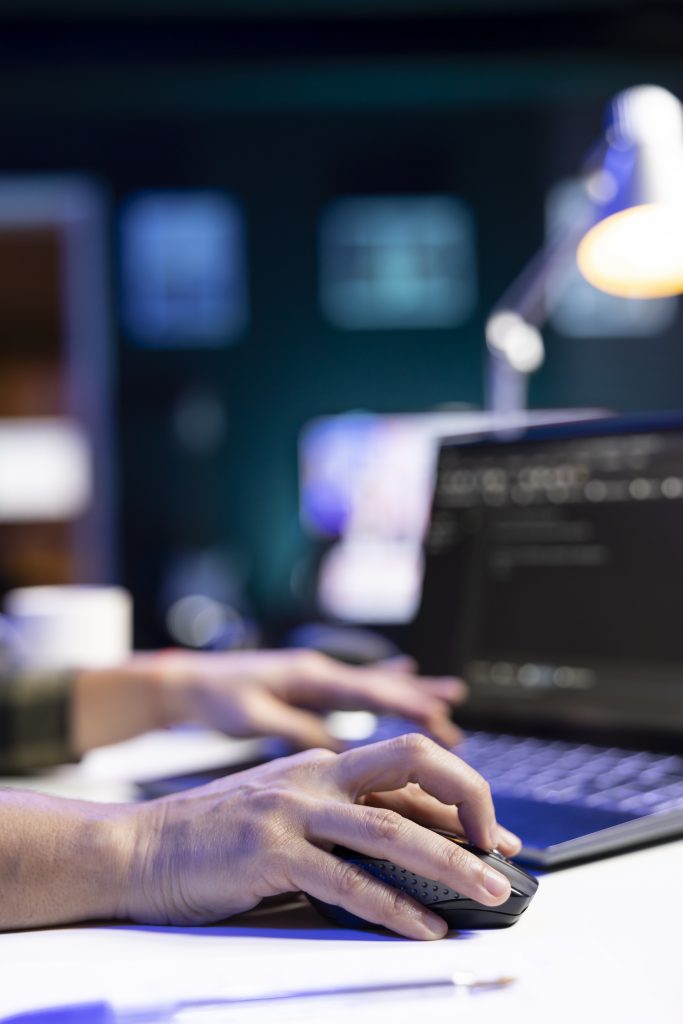 person codes and manages system on laptop