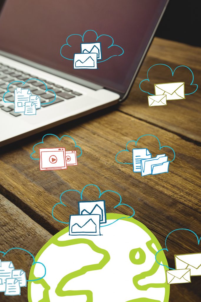 composite image of a laptop put on a wooden desk with icons